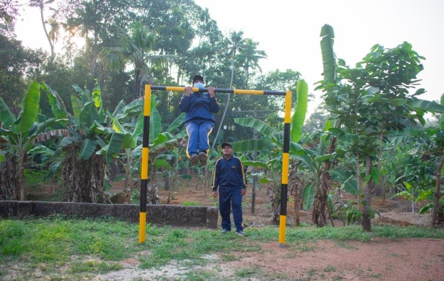 Trainee jumping over a hurdle on the training ground